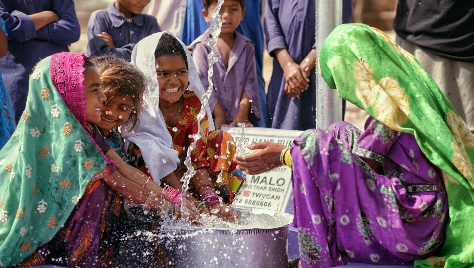 Women drawing water at a hand pump